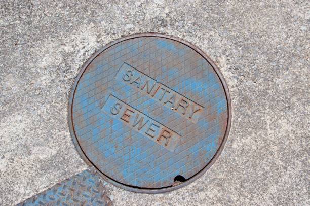 Manhole cover for a sanitary sewer