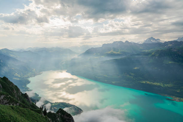 High angle view of Brienz lake from Augstmatthorn in summer  with rays of light playing on the surface of the lake