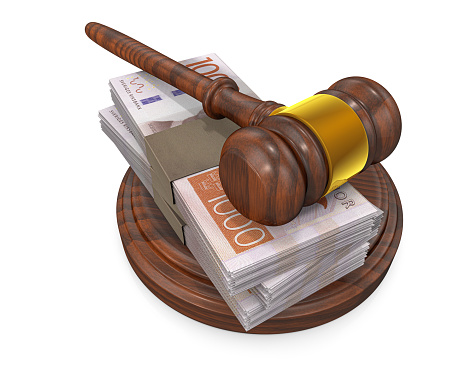 Judge gavel and stack of Swedish Kronas bills
