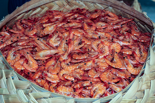 Many dried shrimp, preserved with salt, inside a basket, of indigenous origin, made of palm leaves, called by the people of Maranhão as cofo