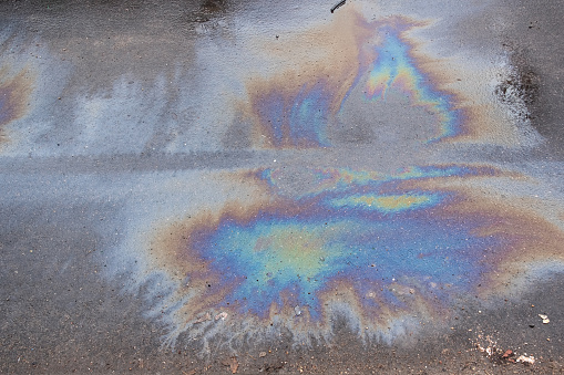 Oil Petrol Pollution Rainbow Gasoline Leak on Pavement.