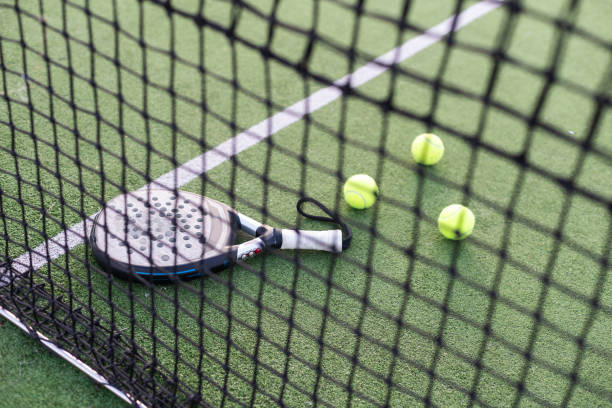 istock Paddle tennis racket, ball and net on the grass 2146648781