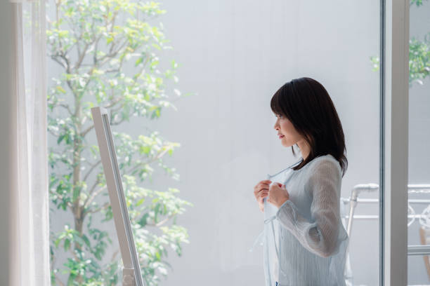 istock Young woman changing clothes at home 2146678580