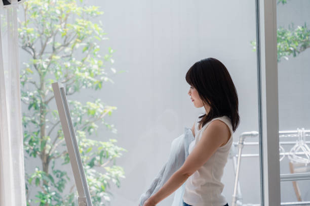 istock Young woman changing clothes at home 2146678583