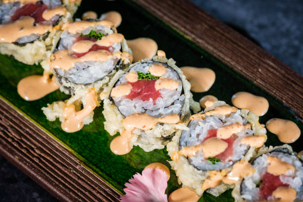 istock Tasty sushi rolls served on tray on marble surface 2146682276