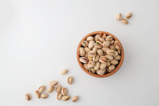 istock Roasted and salted pistachios in shell on white background 2146692189