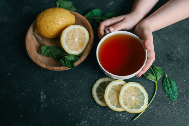 istock Glass cup with hot tea and lemon on table 2146696392