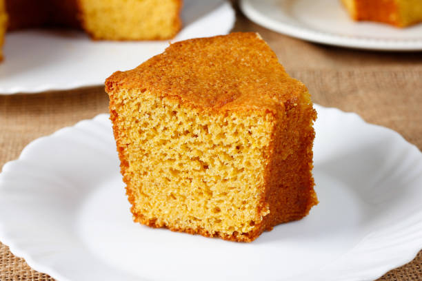 istock corn cake on white plate on rustic wooden table. Typical Brazilian party food. 2146700145