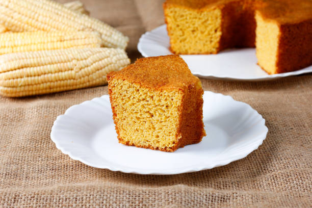 istock corn cake on white plate on rustic wooden table. Typical Brazilian party food. 2146700148