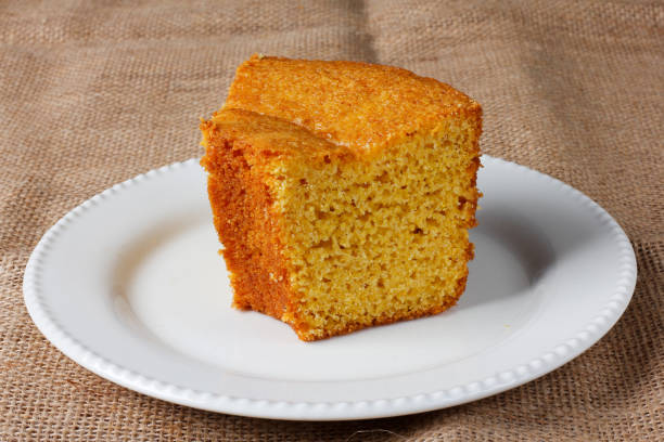 istock corn cake on white plate on rustic wooden table. Typical Brazilian party food. 2146700154