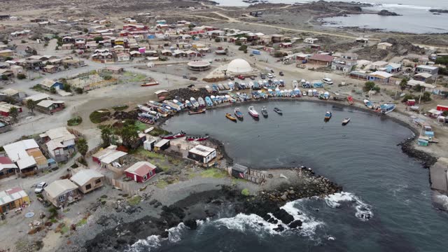 Aerial orbits protected fishing harbour, Caleta Chanaral, Chile coast