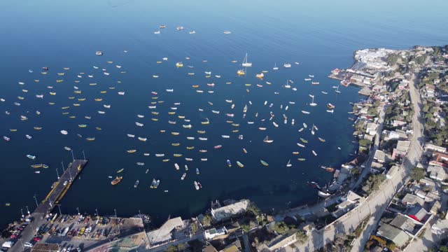 Flyover of picturesque fishing village marina, boats in Tongoy Chile