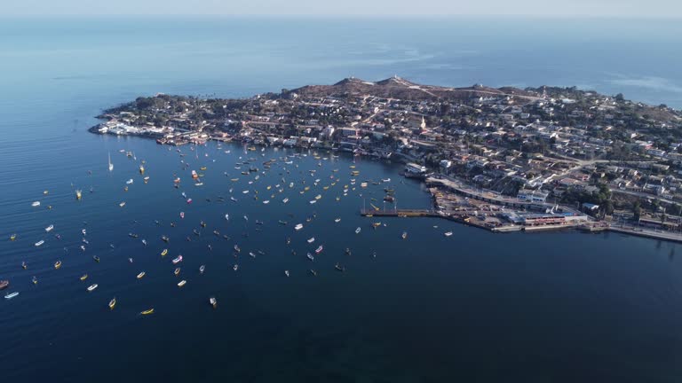 Aerial: Coastal headland village of Tongoy Chile with fishing harbor