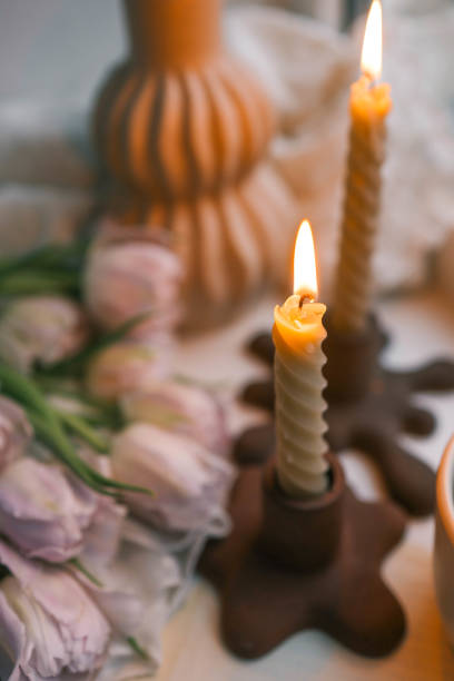 istock Spring aesthetics burning candles on candlesticks and pink tulips 2146713064