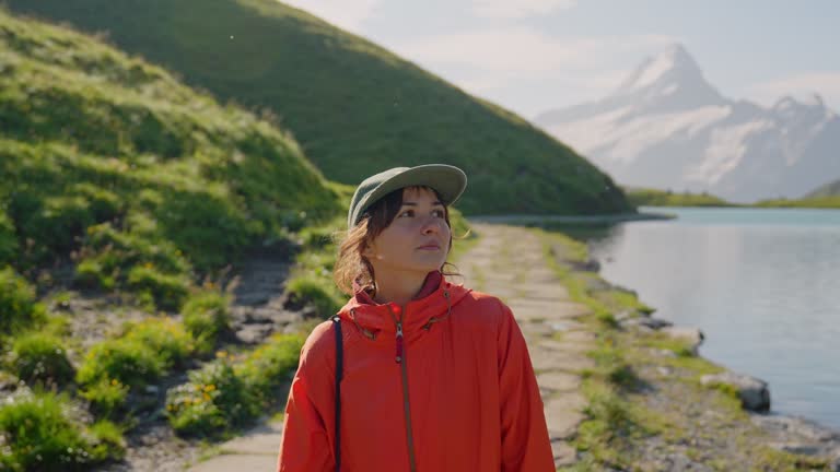 Cheerful woman on hiking trail near Bachalpsee in  Switzerland