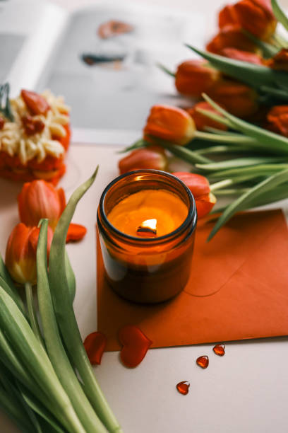 istock Candle and bouquet of red tulips, spring aesthetics 2146720499