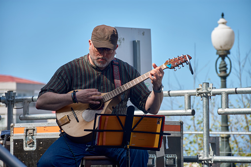 Vigo, Pontevedra, Spain; April 7, 2024; A member of a band plays the mandolin at the festivals of the Reconquista of Vigo