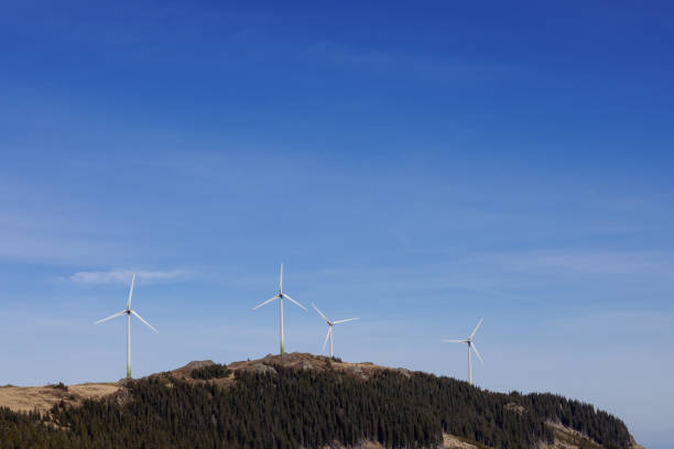 Windmills on a mountain in the Austrian Alps against the blue sky