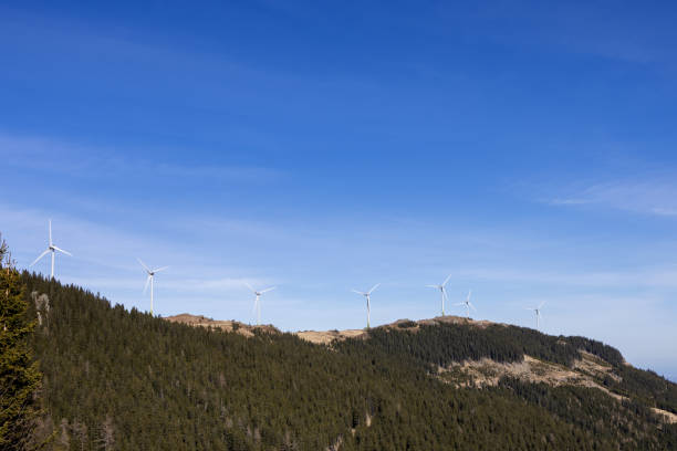 Windmills on a mountain in the Austrian Alps against the blue sky