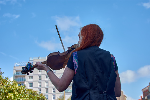 Vigo, Pontevedra, Spain; April 7, 2024; A woman belonging to a band plays the violin at the Reconquista festivities of Vigo