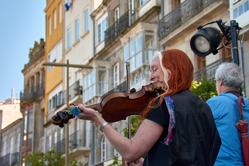 Vigo, Pontevedra, Spain; April 7, 2024; A woman belonging to a band plays the violin at the Reconquista festivities of Vigo