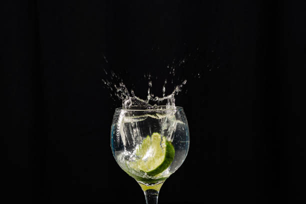 istock A band of lemon falling into a wine glass with water. Splash effect. 2146837803