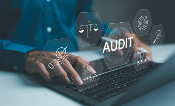 istock business audit concept. Professional conducting a business audit using laptop with virtual interface displaying audit, and compliance data analysis icons. Evaluation financial, standard certification, 2146845551
