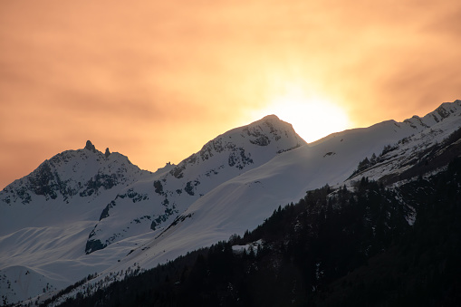A glowing sunset behind the Gotthard mountain range in Switzerland.