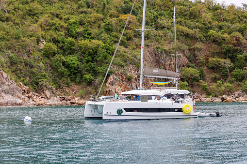 Tortola, British Virgin Islands - March 27, 2024: Catamarans and tour boats in the bays off the shores of Norman Island in the British Virgin Islands
