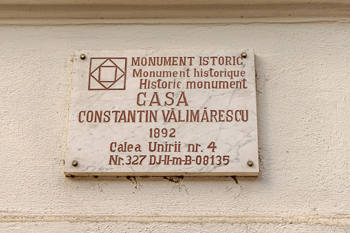 Craiova, Romania - March 16, 2024: Marble Stone Memorial Plaque House Constantin Valimarescu Historic Monument at Calea Unirii Street.