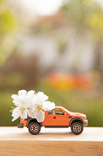 Model pink retro toy car on green background. Miniature car with copy space