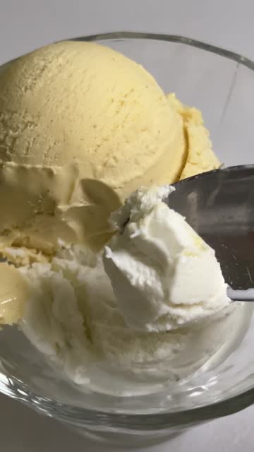Vanilla ice cream scooped out from container with a spoon, Food concept