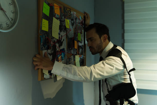 istock Caucasian detective with a board of connected clues, deeply immersed in solving a case 2146982225