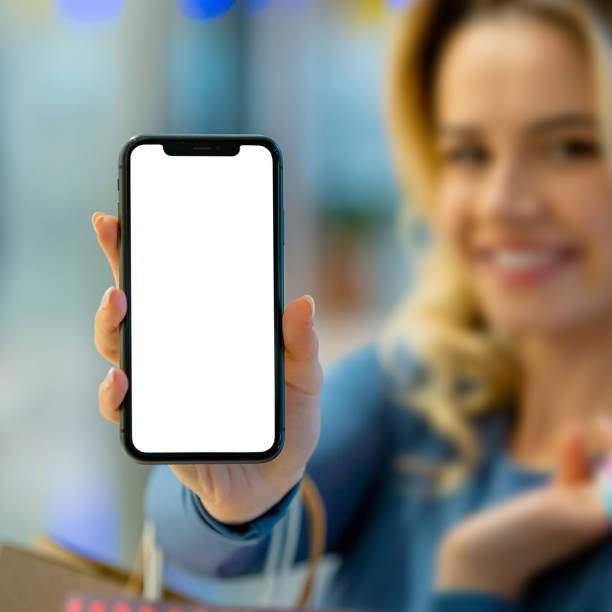 Smiling Shopper: Woman Holds Smartphone Screen with Blank Display