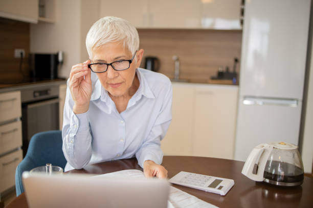 istock Senior woman is going through bills and finances 2147082582