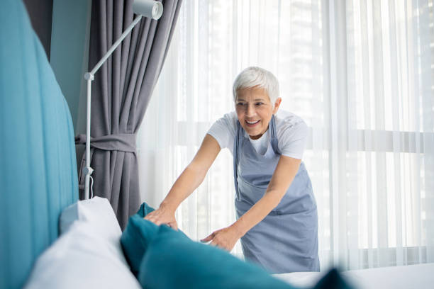 istock Housekeeper is making the bed in the hotel 2147083694