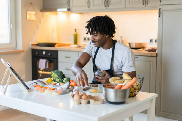 istock Using a cooking video to learn to prepare food 2147096781