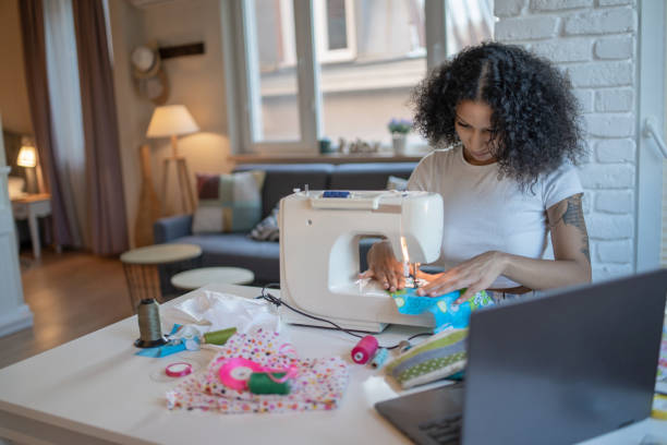 istock Seamstress using her skills for a freelance sewing market 2147096784