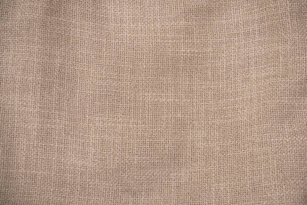 istock Hessian sackcloth woven jute burlap fabric cloth textile texture pattern background in brown beige aged color 2147097876