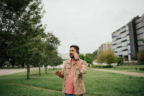 istock Latino man using cell phone outdoors 2147126913
