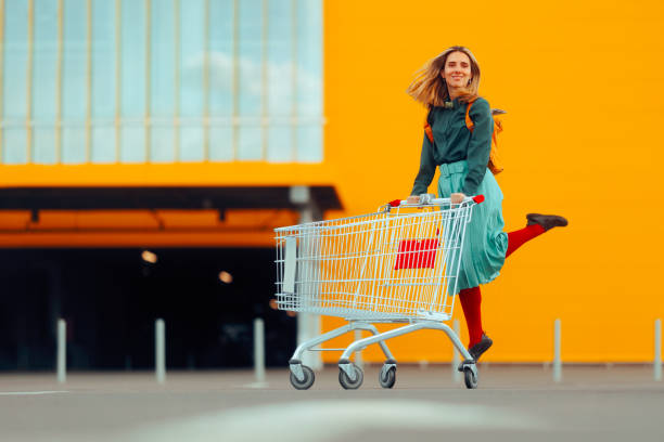 istock Cheerful Shopper Jumping with Joy Pushing Shopping Cart 2147145449