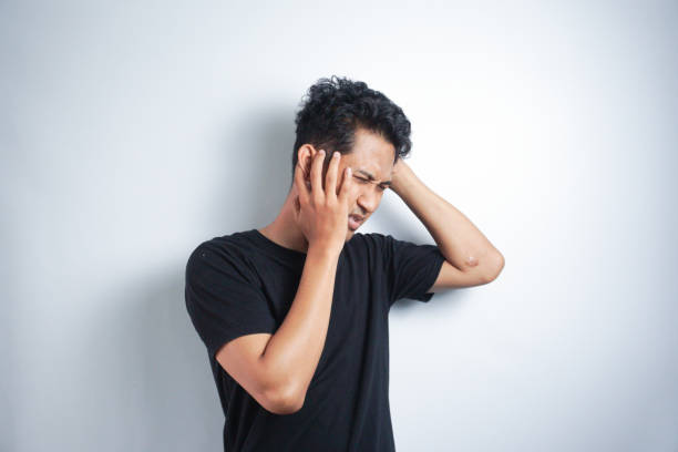 istock Man with earache is holding his aching ear body pain concept 2147217156