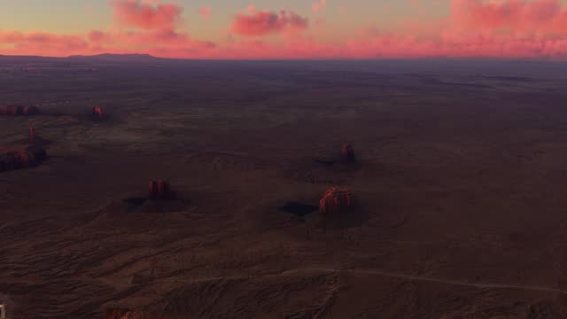Sunset aerial view of Merrick Butte - East Mitten Butte - West Mitten Butte desert in Arizona. United States