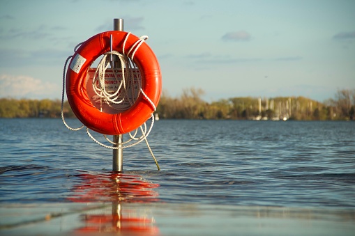 Life preserver on pole above water