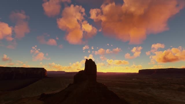 Aerial shot at sunset of the desert at Big Indian Chief monolith in Monument Valley in Arizona. United States