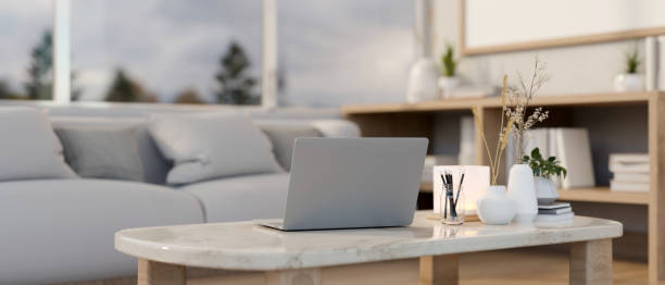 istock A laptop computer on a luxury white marble coffee table in a comfortable contemporary living room. 2147319059
