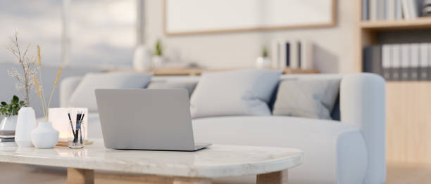 istock A laptop computer on a luxury white marble coffee table in a comfortable contemporary living room. 2147319060