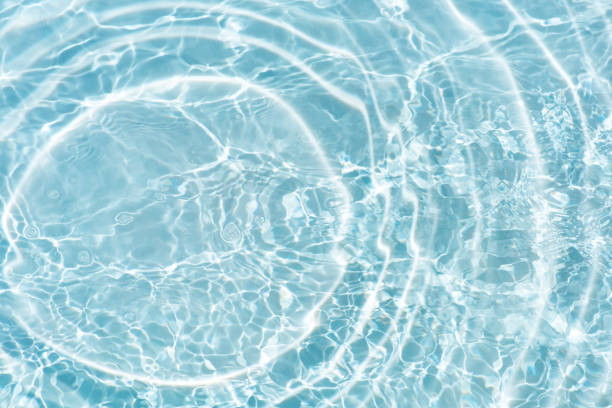 istock Bluewater waves on the surface ripples blurred. Defocus blurred transparent blue colored clear calm water surface texture with splash and bubbles. Water waves with shining pattern texture background. 2147355259