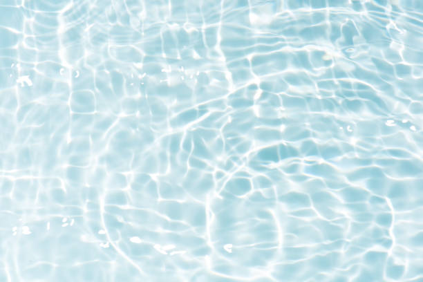 istock Bluewater waves on the surface ripples blurred. Defocus blurred transparent blue colored clear calm water surface texture with splash and bubbles. Water waves with shining pattern texture background. 2147355795