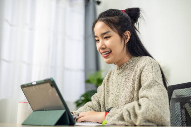 istock Attractive young woman using digital tablet to work in home office. 2147368687